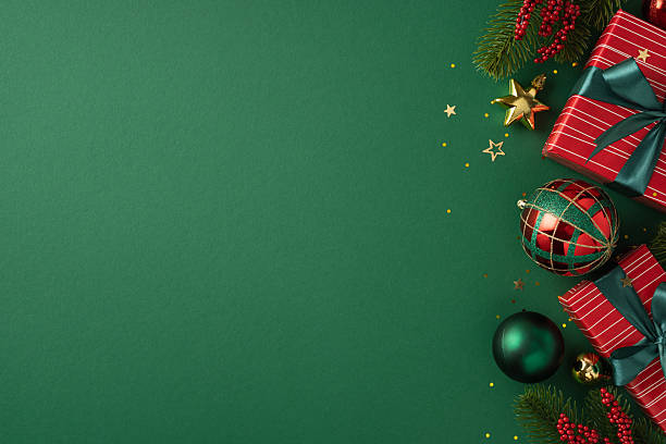 istock Festive holiday composition featuring Christmas presents, ornaments, and decorations arranged on a green surface 2225270790