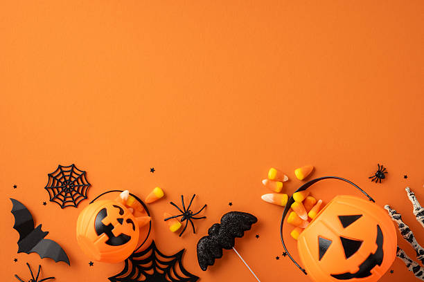 istock A Halloween-themed composition featuring pumpkins, candy corn, and festive decorations on orange 2225270804