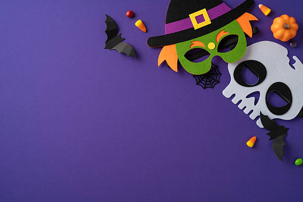 istock Creative composition featuring Halloween masks, candy, and decorations arranged on a purple backdrop 2225270807