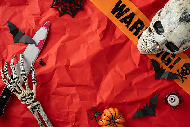istock Spooky Halloween arrangement featuring a skull, skeleton hand, and eerie decor in red tones 2225270830