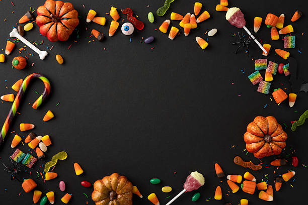 istock Colorful candy, spooky decorations, and pumpkins arranged on a dark backdrop for Halloween 2225270853