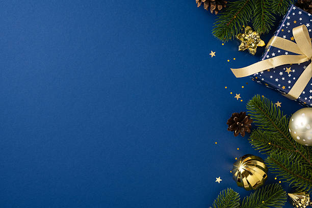 istock Luxurious gold accents and festive elements, including wrapped gift and foliage, create a celebratory ambiance 2225270859