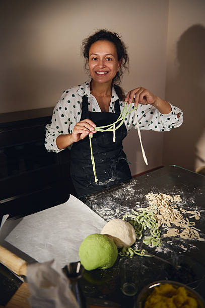 Woman Happily Preparing Homemade Pasta in a Cozy Kitchen Setting