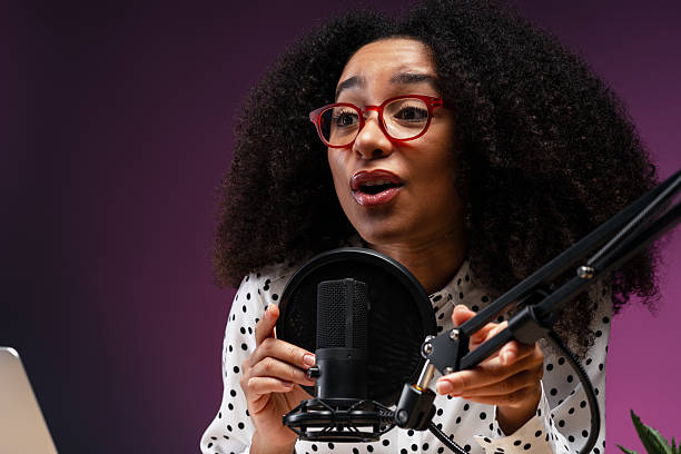 istock Young woman recording a podcast in a professional studio 2225273499