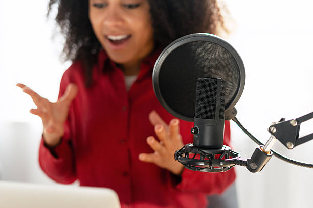 istock African American podcaster creating online content with microphone and laptop selective focus 2225273792