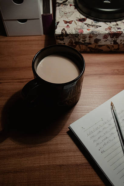 istock Coffee Cup and Notebook on Wooden Desk 2225274712
