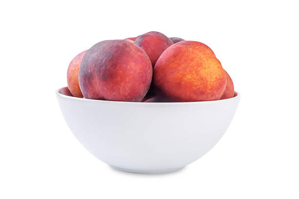 istock Fresh raw peaches in a white bowl on a white isolated background 2225274750