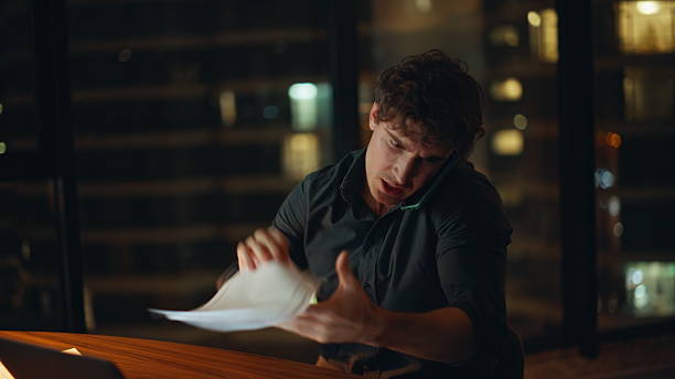 istock Calling businessman crumpling papers at night office closeup. Furious executive 2225277951