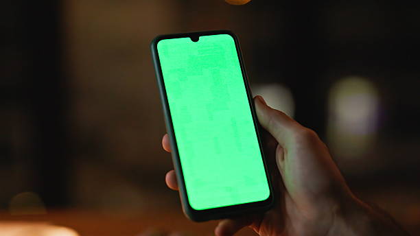 istock Fingers tapping mockup cellphone at dark room closeup. Unrecognizable freelancer 2225278670