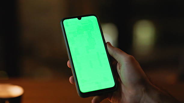 istock Online customer scrolling chroma key mobile phone at night home closeup. 2225278877