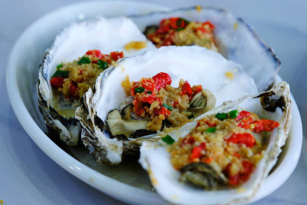 istock grilled oysters with minced garlic and red chili 2225278945