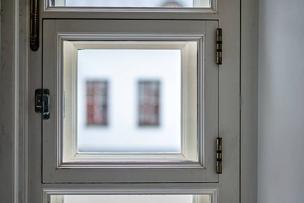 istock Bright and simple window frame with blurred view of a building in the background 2225278970