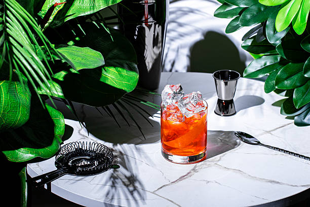 istock Refreshing non-alcoholic negroni mocktail served on a stylish table among lush greenery in a modern lounge setting 2225281020