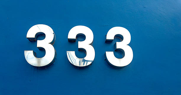 istock Close up building number 333 on concrete wall 2225281325