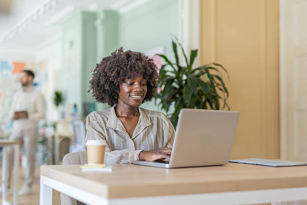 istock Joyful woman working on her laptop in an office 2225282634