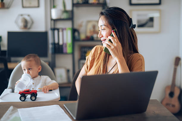 istock Single asian mother multitasking between work and taking care of small child. 2225282818