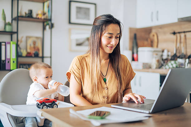 istock Single asian mother multitasking between work and taking care of small child. 2225282831