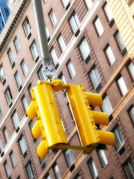 istock Urban yellow traffic lights against a brick facade in a cityscape setting 2225283018