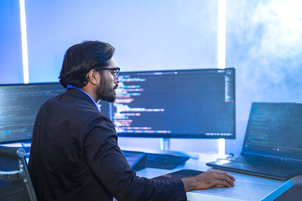 istock Diverse team of AI developers collaborating in a modern office. Indian male leading a discussion with Asian and Hispanic female colleagues on a machine learning project. 2225284332