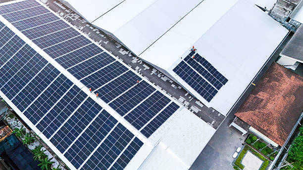 istock Rooftop solar panel installation set against a backdrop of lush green mountains, showcasing clean energy solutions in harmony with natural landscapes. 2225286125