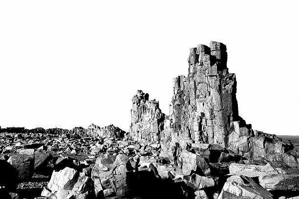 Black and white closeup Basaltic volcanic columns, background with copy space, full frame horizontal composition