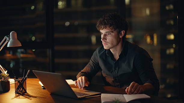 istock Amazed freelancer celebrating online win looking laptop at night office closeup. 2225287997