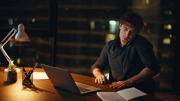 istock Business manager consulting mobile phone sitting dark workplace closeup. 2225290826