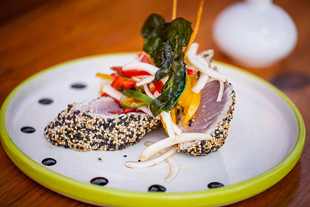 Elegant raw cured tuna appetizers canapes with caviar and avocado served as starter in luxury fine dining restaurant for lunch