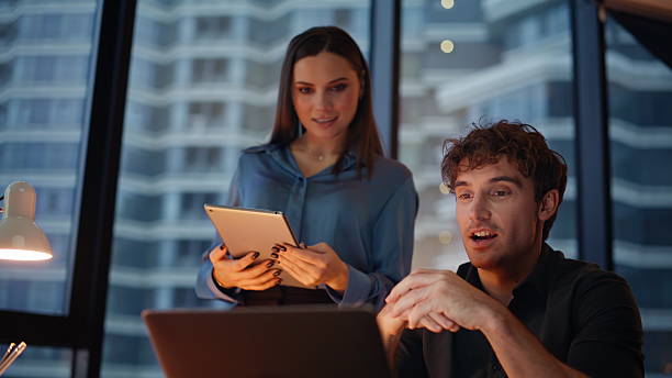 istock Partners discussing project videocall collaborating in dark office closeup. 2225291951