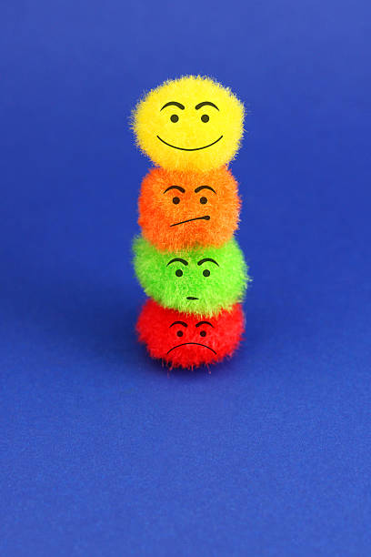 Group of colorful plush spheres with expressions - vertical format