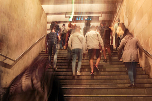 Several people completely out of focus and blurred, walking up a stairway in the Lisbon metro