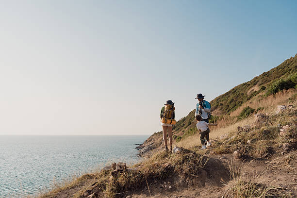 istock A couple goes for a walk along the seaside to study nature resources. 2225303203