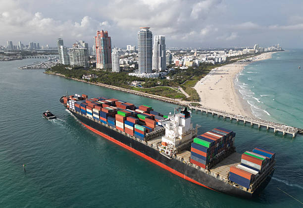 istock Port of Miami. Cargo ship with container in Miami, aerial view. Freight container on cargo vessel. Cargo ship vessel leaving port. Container ship. Export and import. Cargo business. Miami beach 2225304630
