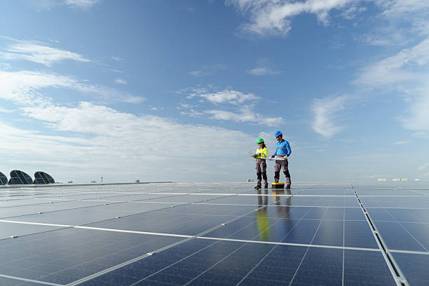 istock Male and female engineers inspect solar panels recently installed on a high-rise building. 2225305321