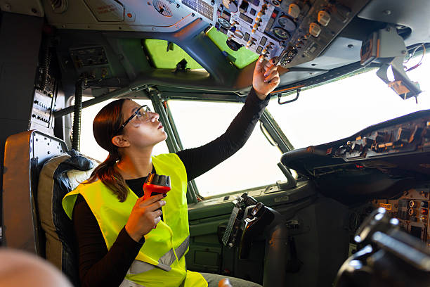 istock Young female engineer checking the instrument panel in the airplane cockpit 2225309429