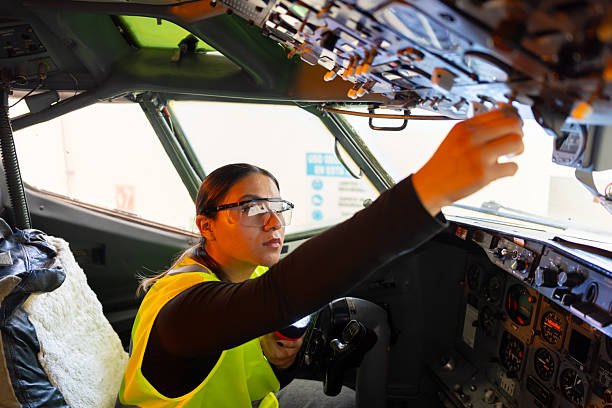 istock Young female engineer checking the instrument panel in the airplane cockpit 2225309435