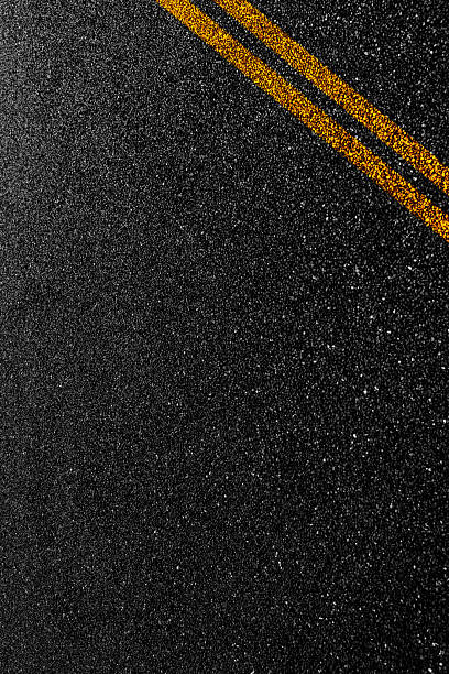 istock Double orange line on asphalt road 2225310946