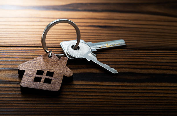 House shaped with a key on wooden table