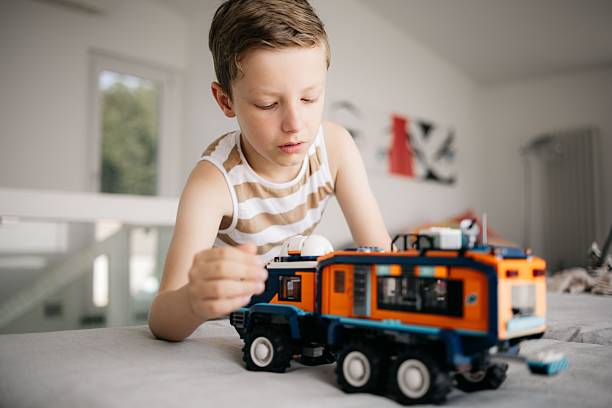 istock Boy playing with toy truck indoors 2225312447