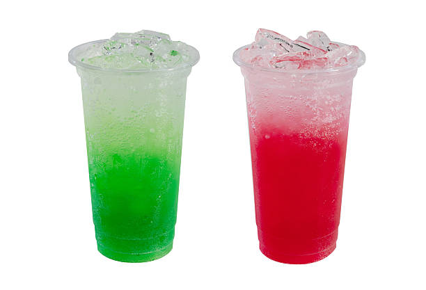 Green and red iced soda drinks in plastic cup