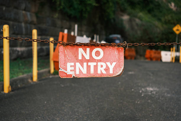 istock Old faded red no entry sign on a rusty chain 2225315112