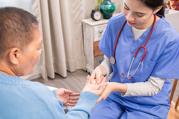 istock Nurse and older patient making eye contact while holding hands, expressing warmth, empathy, and support in home-based senior care environment, healthcare, caregiver, encourage, take care. 2225316150