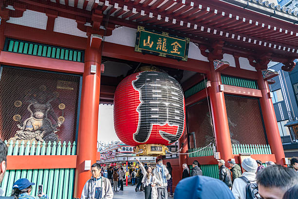 Tokyo, Japan - January 20, 2025: Sensoji or Asakusa Kannon Temple, is a Buddhist temple located in Asakusa dedicated to the bodhisattva Kannon is Tokyo's oldest temple, and one of its most significant. People can be seen in front of the temple and taking photos.