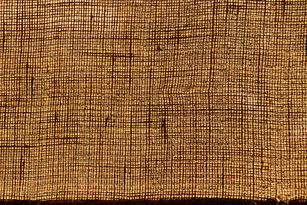 istock Textured brown fabric close-up in sunlight as texture for background, template 2225318333