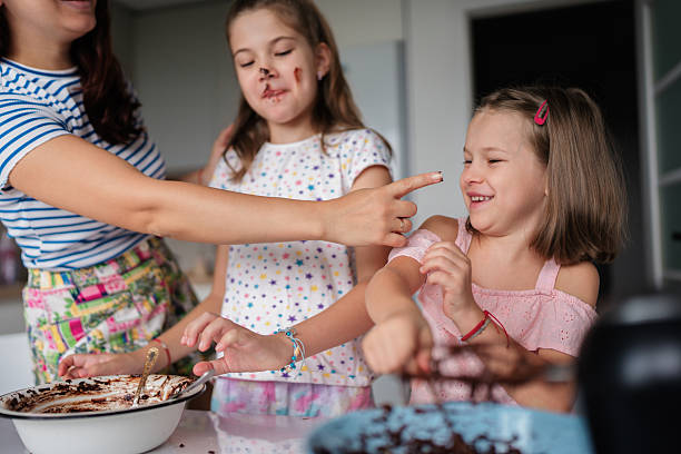 istock Mother and daughters baking together in the kitchen 2225319482