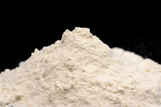 istock Close-up of protein powder on black background 2225319742