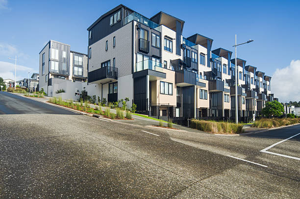 A row of modern detached houses facing a clean residential road, showcasing suburban architecture and quiet neighborhood living.