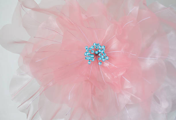 istock Artificial flowers made from pink fabric with blue stamens. 2225327302