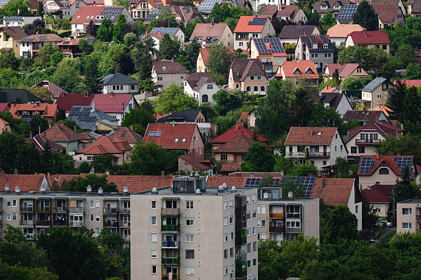 istock Suburban neighborhood with solar rooftops and greenery 2225328795