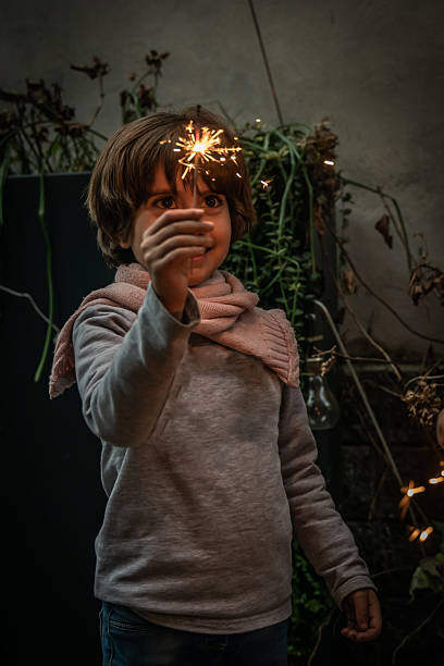 Young child holding a sparkler, creating a festive atmosphere. The scene captures the joy and wonder of christmas celebrations with a touch of magic and light